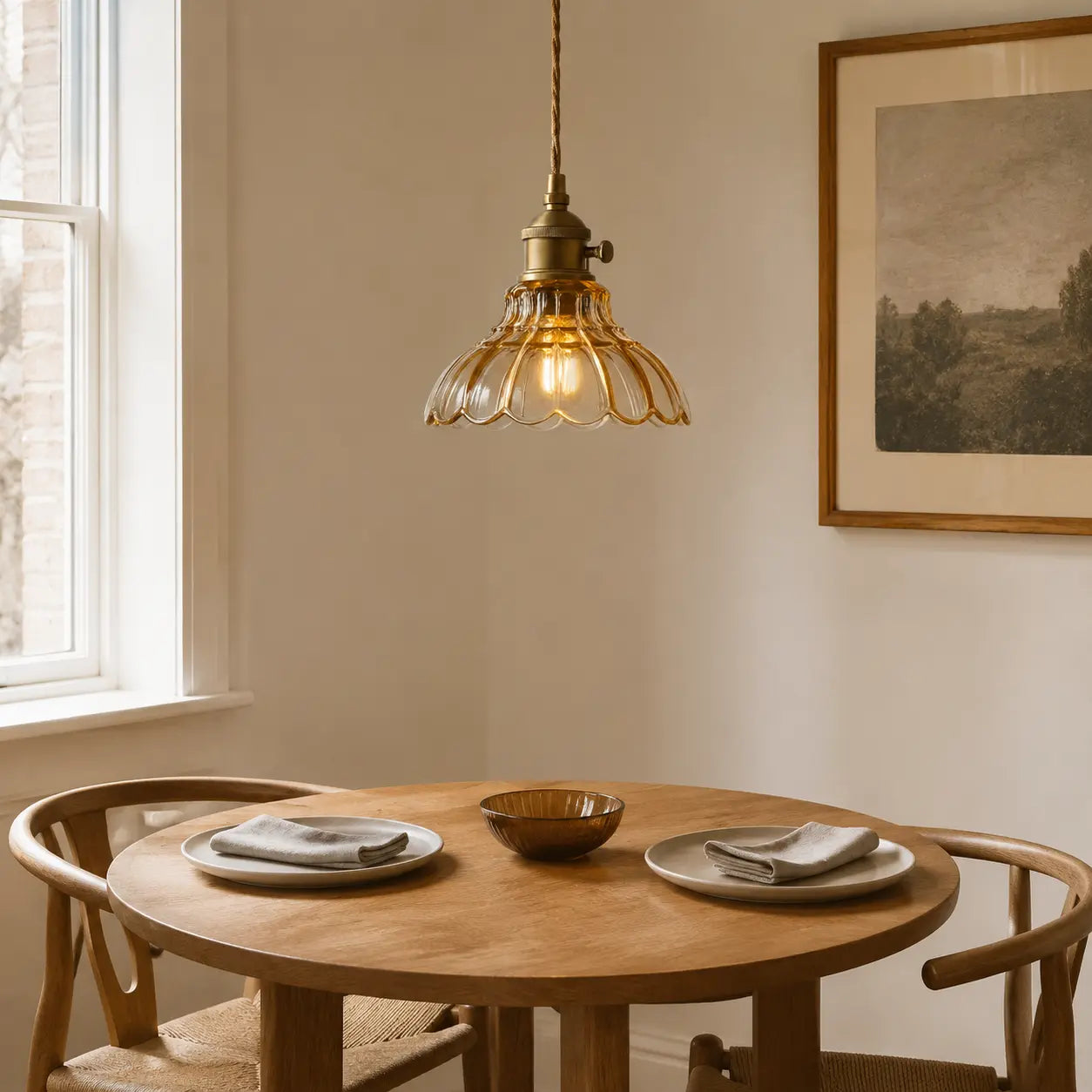 Amber flower glass pendant light above a round oak dining table