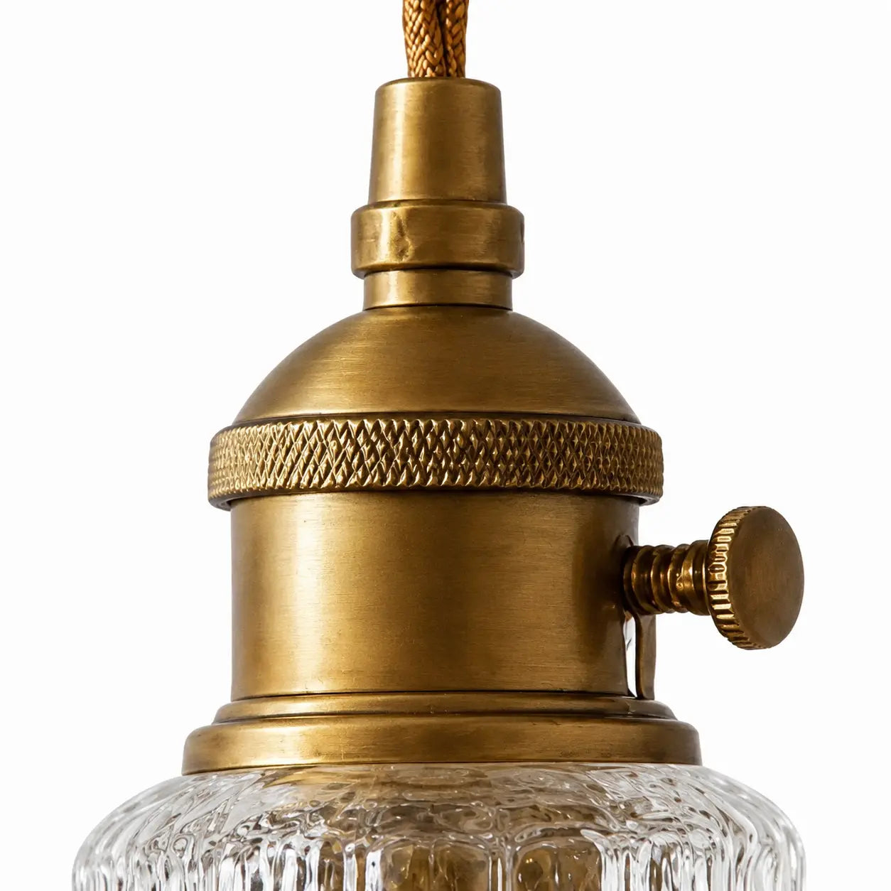 Close detail of aged brass-tone lampholder and side knob